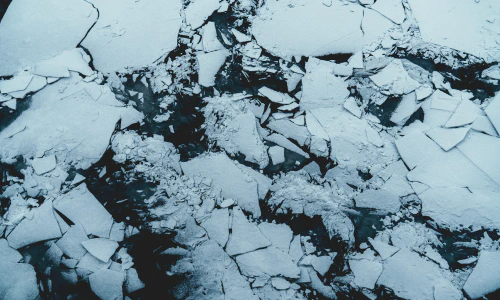 A photo of an ice floe with big chunks shattered and overlapping.
