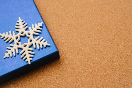 Blue box with Christmas present and white snowflake.